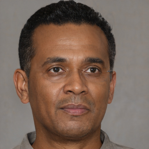 Neutral black adult male with short  brown hair and brown eyes