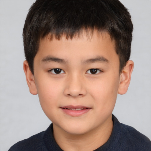 Joyful white child male with short  brown hair and brown eyes