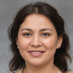 Joyful white young-adult female with medium  brown hair and brown eyes