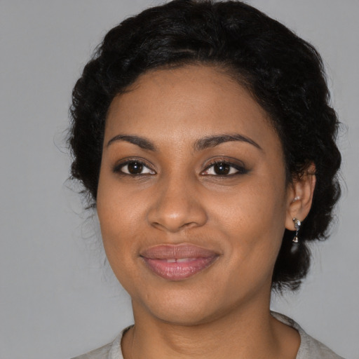 Joyful black young-adult female with medium  black hair and brown eyes
