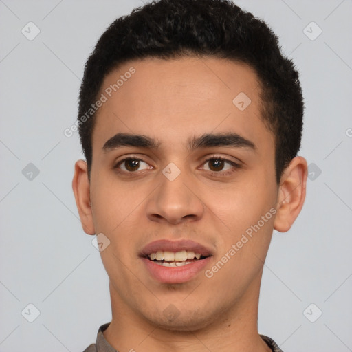 Joyful latino young-adult male with short  black hair and brown eyes