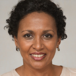 Joyful black adult female with short  brown hair and brown eyes