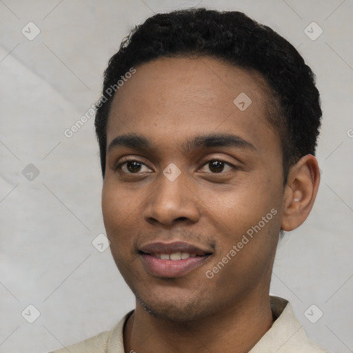 Joyful black young-adult male with short  black hair and brown eyes