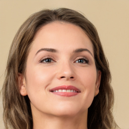 Joyful white young-adult female with long  brown hair and grey eyes