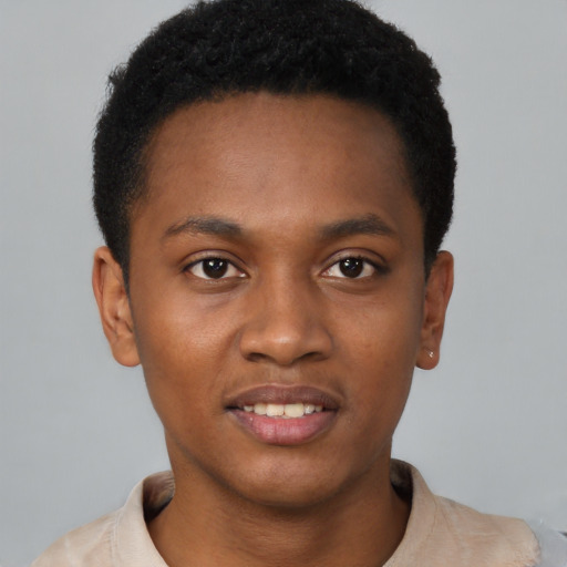 Joyful latino young-adult male with short  brown hair and brown eyes