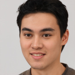 Joyful asian young-adult male with short  brown hair and brown eyes