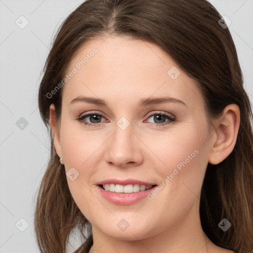 Joyful white young-adult female with long  brown hair and grey eyes