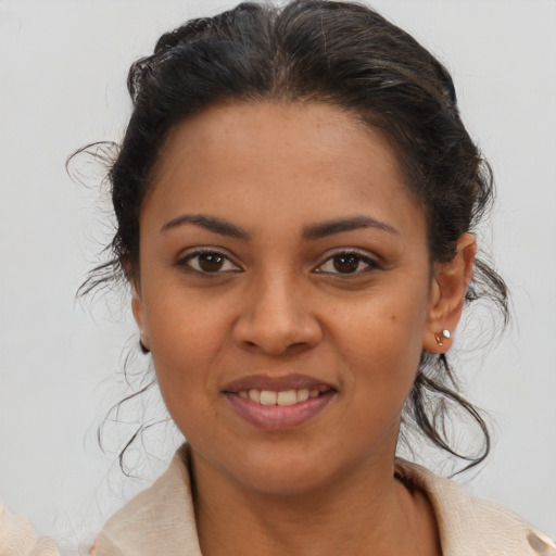 Joyful latino young-adult female with medium  brown hair and brown eyes