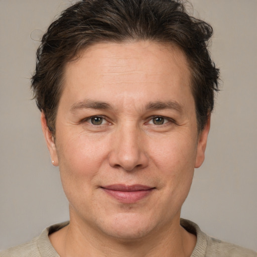 Joyful white adult male with short  brown hair and grey eyes