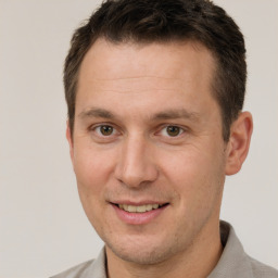 Joyful white adult male with short  brown hair and brown eyes