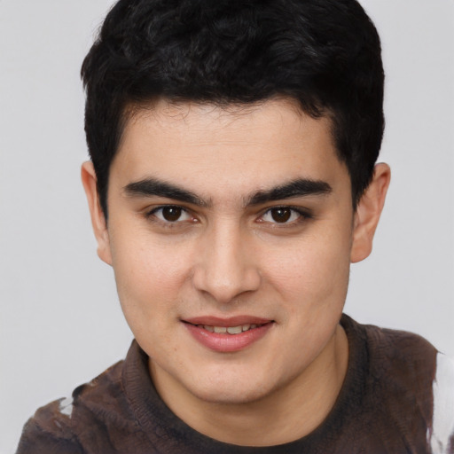 Joyful asian young-adult male with short  brown hair and brown eyes