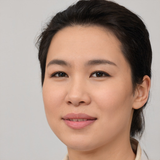 Joyful asian young-adult female with medium  brown hair and brown eyes