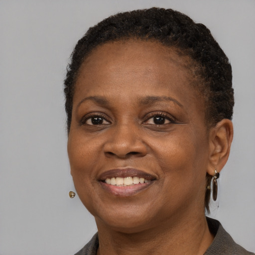 Joyful black adult female with short  brown hair and brown eyes
