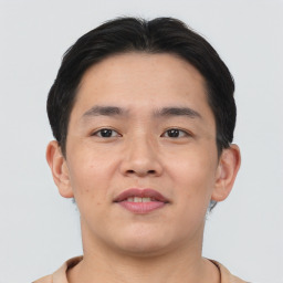 Joyful asian young-adult male with short  brown hair and brown eyes