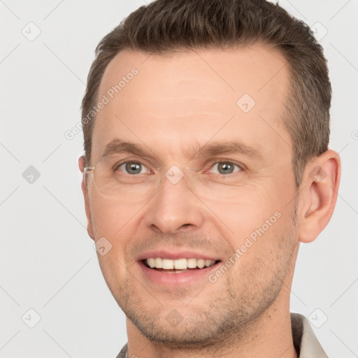 Joyful white adult male with short  brown hair and grey eyes