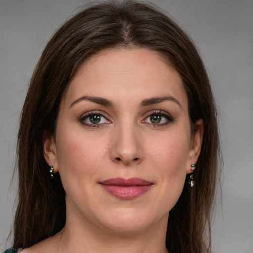 Joyful white young-adult female with medium  brown hair and green eyes