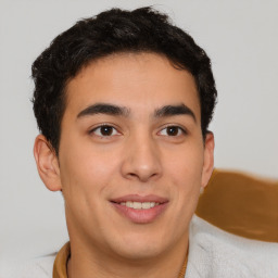 Joyful latino young-adult male with short  brown hair and brown eyes