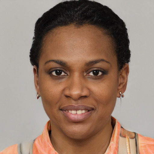 Joyful black young-adult female with short  black hair and brown eyes