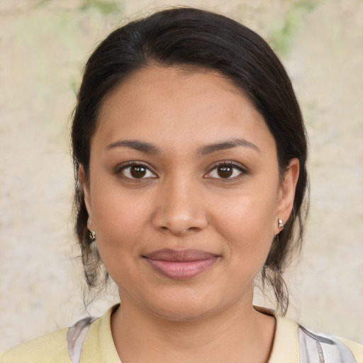 Joyful latino young-adult female with medium  brown hair and brown eyes