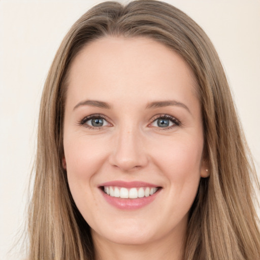 Joyful white young-adult female with long  brown hair and green eyes