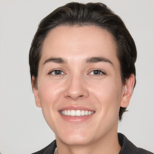 Joyful white young-adult male with short  black hair and brown eyes