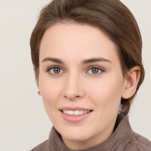 Joyful white young-adult female with short  brown hair and grey eyes