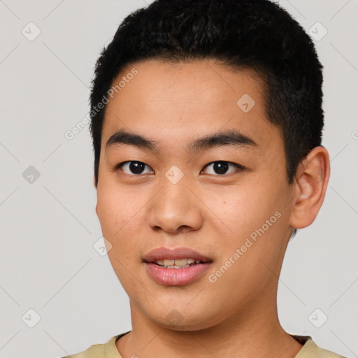 Joyful asian young-adult male with short  black hair and brown eyes