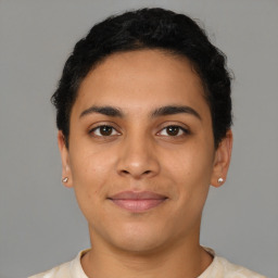 Joyful latino young-adult male with short  brown hair and brown eyes