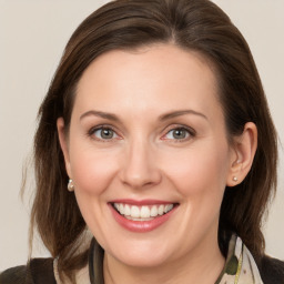 Joyful white young-adult female with medium  brown hair and grey eyes