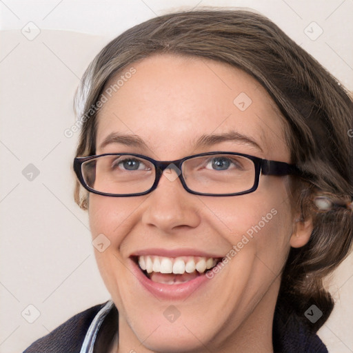 Joyful white adult female with medium  brown hair and blue eyes