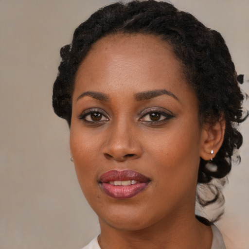 Joyful black young-adult female with short  brown hair and brown eyes