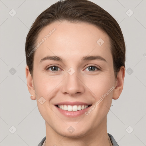 Joyful white young-adult female with short  brown hair and grey eyes