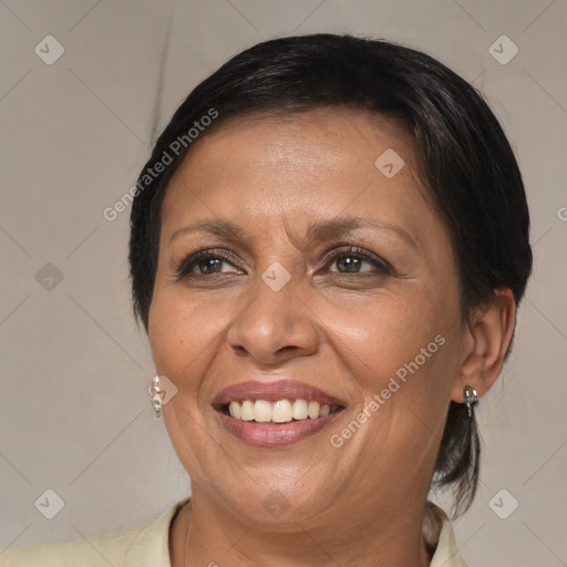 Joyful black adult female with medium  brown hair and brown eyes