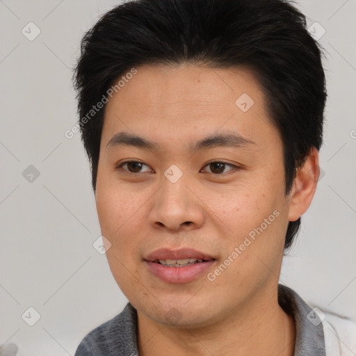 Joyful asian young-adult male with short  brown hair and brown eyes