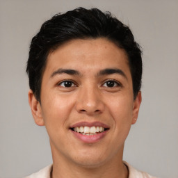 Joyful latino young-adult male with short  brown hair and brown eyes