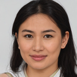 Joyful latino young-adult female with medium  brown hair and brown eyes