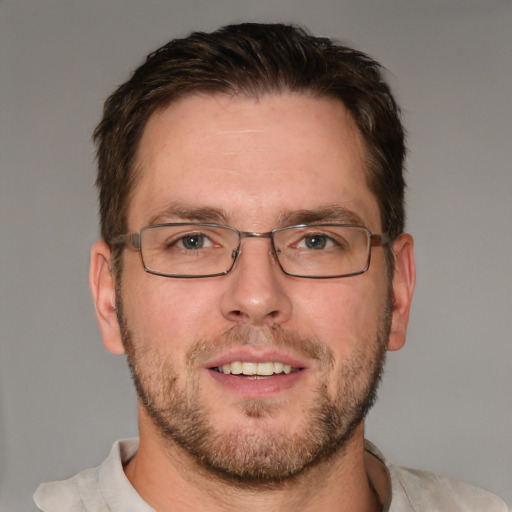 Joyful white adult male with short  brown hair and brown eyes