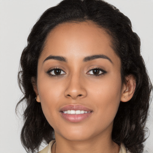 Joyful latino young-adult female with long  brown hair and brown eyes