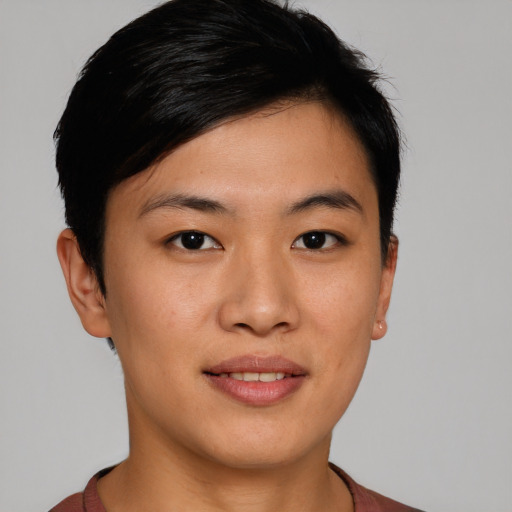 Joyful asian young-adult female with short  brown hair and brown eyes