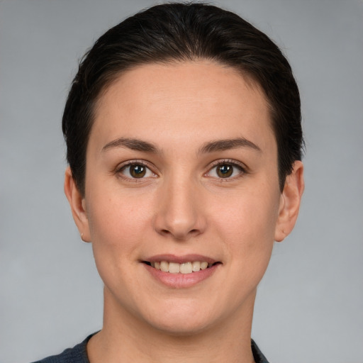 Joyful white young-adult female with short  brown hair and brown eyes