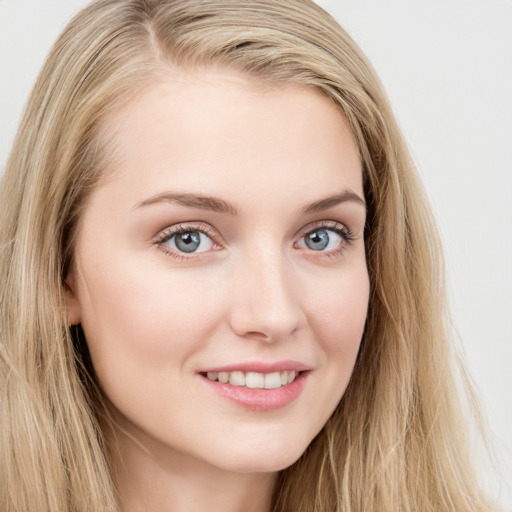 Joyful white young-adult female with long  brown hair and blue eyes