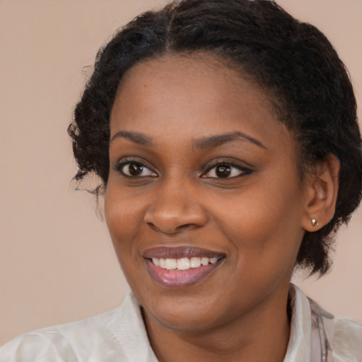 Joyful black young-adult female with medium  brown hair and brown eyes