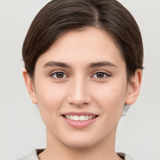 Joyful white young-adult female with short  brown hair and brown eyes