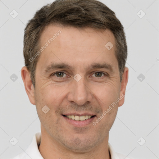 Joyful white adult male with short  brown hair and brown eyes