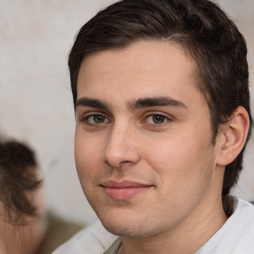 Joyful white young-adult male with medium  brown hair and brown eyes