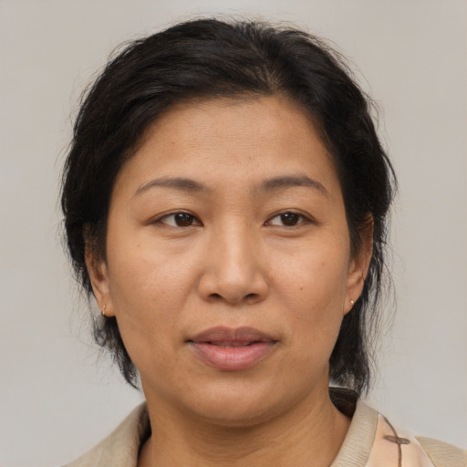 Joyful asian adult female with medium  brown hair and brown eyes