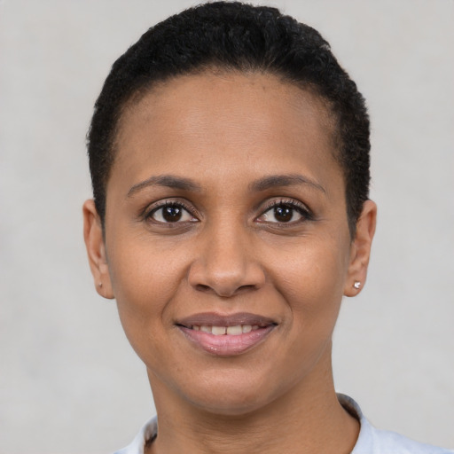 Joyful latino young-adult female with short  black hair and brown eyes