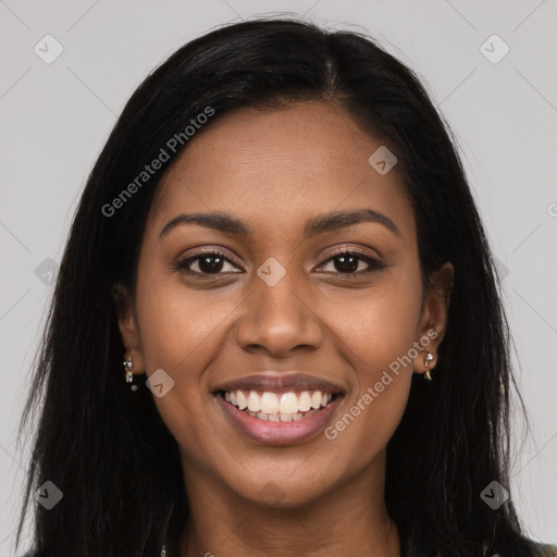 Joyful black young-adult female with long  brown hair and brown eyes