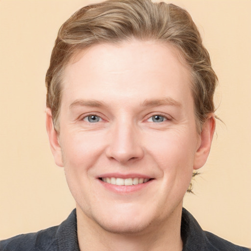 Joyful white adult male with short  brown hair and grey eyes