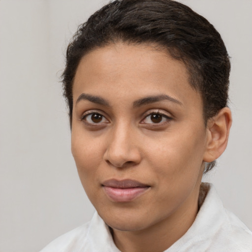 Joyful latino young-adult female with short  brown hair and brown eyes